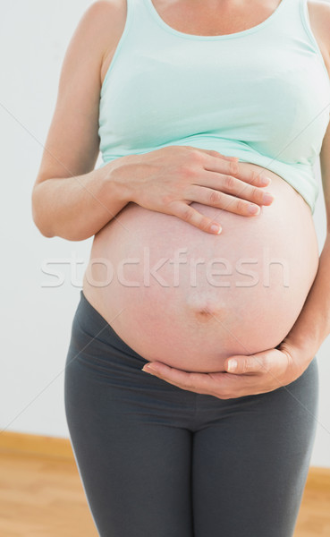 Pregnant woman holding her large baby bump Stock photo © wavebreak_media