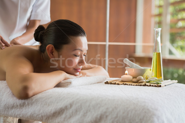 Brunette enjoying a massage with beauty treatments beside Stock photo © wavebreak_media