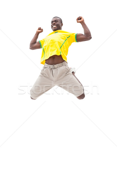 Happy brazilian football fan jumping up Stock photo © wavebreak_media