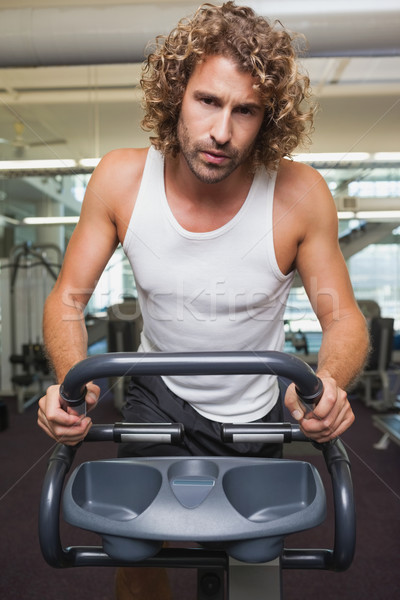 Fit man using exercise bike Stock photo © wavebreak_media