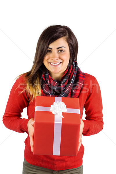 Stock photo: Smiling brunette showing a gift with white bow