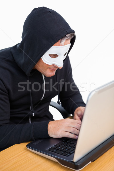 Scassinatore bianco maschera l'hacking laptop computer Foto d'archivio © wavebreak_media
