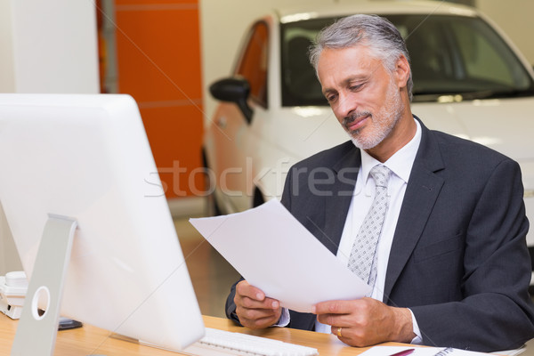 Businessman reading document at office desk Stock photo © wavebreak_media