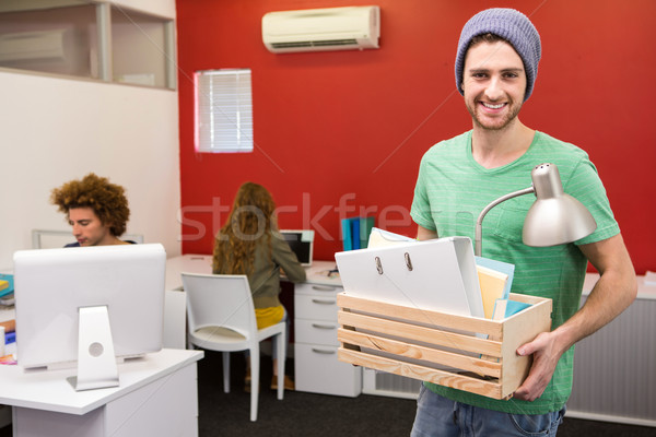 Casual businessman carrying his belongings in box Stock photo © wavebreak_media