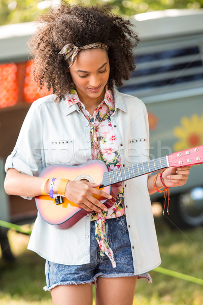 Pretty hipster playing the ukulele Stock photo © wavebreak_media