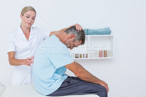 Doctor stretching a man back Stock photo © wavebreak_media