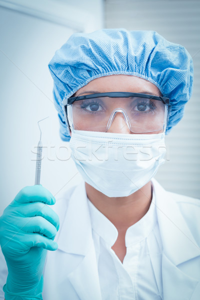 Female dentist wearing surgical mask and safety glasses Stock photo © wavebreak_media