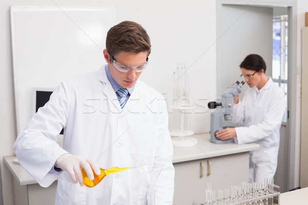 Scientists working attentively with test tube and microscope Stock photo © wavebreak_media