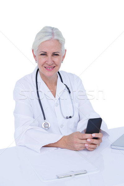  Thinking woman doctor phoning with her smartphone Stock photo © wavebreak_media