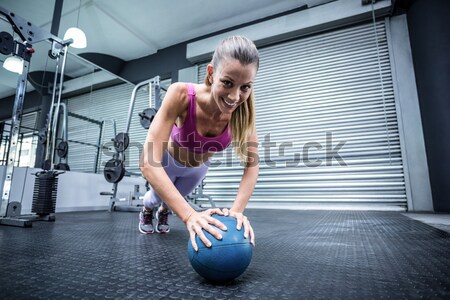 Muscular woman doing push-ups Stock photo © wavebreak_media