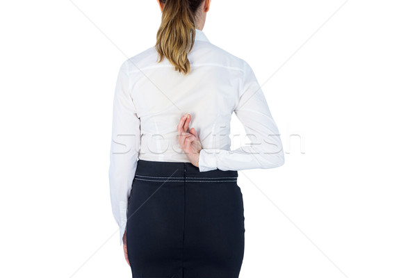 Pretty businesswoman with finger crossed  Stock photo © wavebreak_media