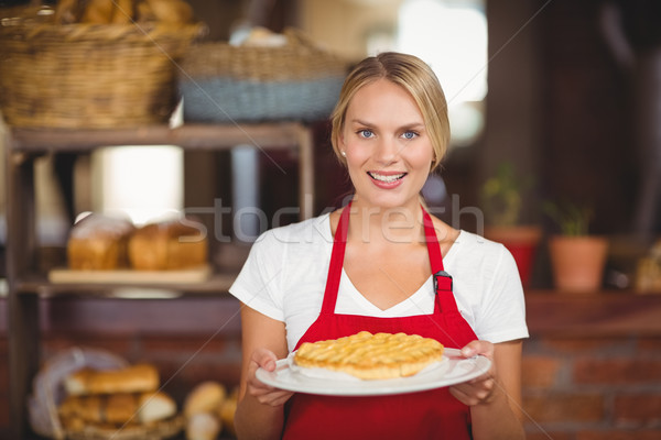 Pretty waitress holding a plate of cake Stock photo © wavebreak_media