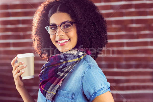 Smiling attractive hipster holding take-away cup Stock photo © wavebreak_media