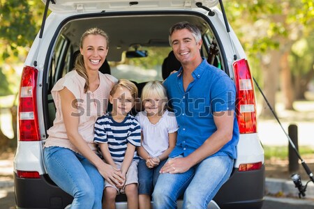 Family sitting in the back of the van against house outline in background Stock photo © wavebreak_media