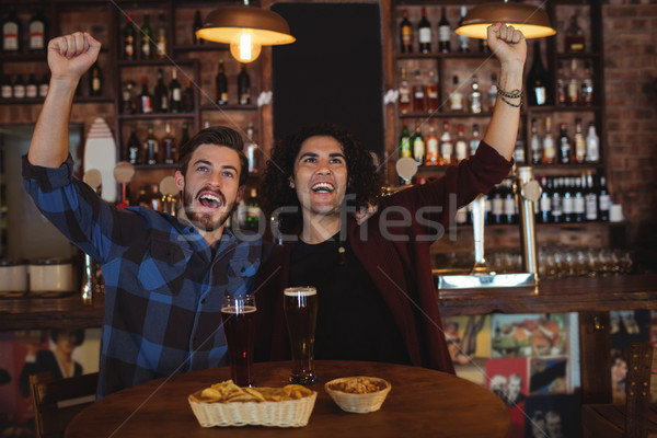Friends having beer in pub Stock photo © wavebreak_media