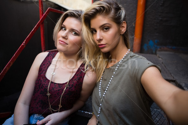 Portrait of friends sitting on staircase Stock photo © wavebreak_media