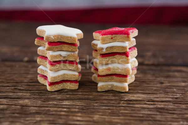 Red and white sugar cookies stacked on wooden table Stock photo © wavebreak_media