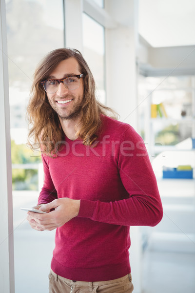 Portrait of happy hipster using mobile phone Stock photo © wavebreak_media