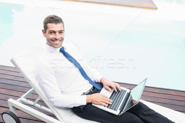 Smarty dressed man using laptop Stock photo © wavebreak_media