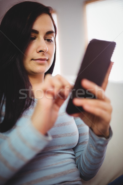 Beautiful woman using mobile phone Stock photo © wavebreak_media