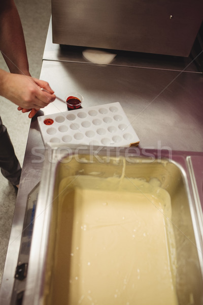 Worker painting a chocolate mould using colored chocolate Stock photo © wavebreak_media