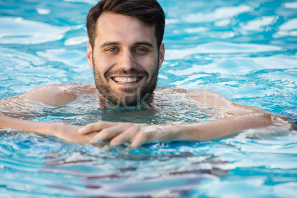 Jeune homme natation gonflable tube piscine amusement [[stock_photo]] © wavebreak_media