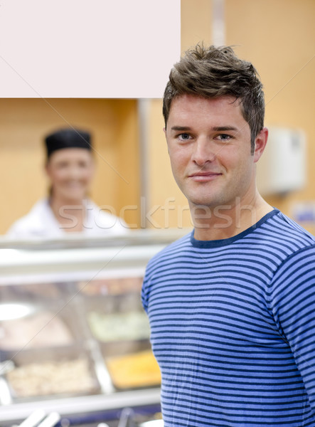 Portrait of a cheerful man choosing his lunch in the cafeteria of his campus Stock photo © wavebreak_media