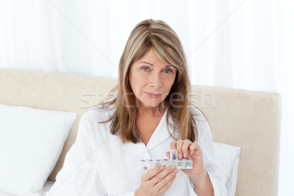Sick woman taking her pills at home Stock photo © wavebreak_media