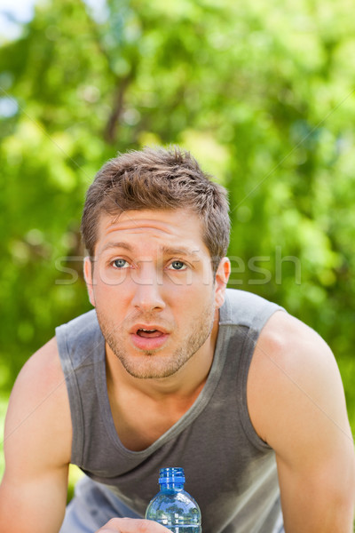 Sporty man drinking water in the park Stock photo © wavebreak_media