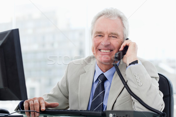 Smiling senior manager on the phone in his office Stock photo © wavebreak_media