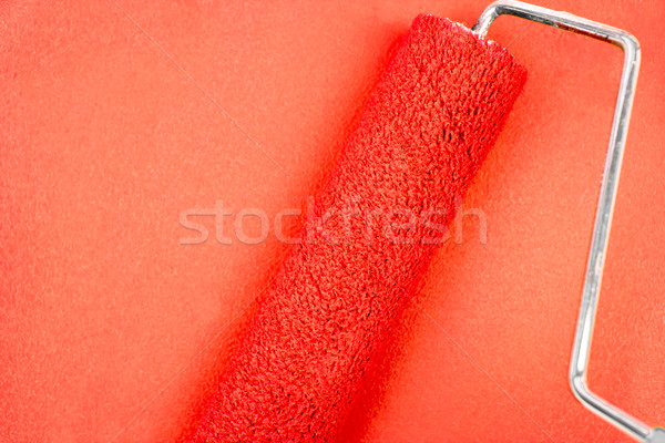 Red background with a paint roller Stock photo © wavebreak_media