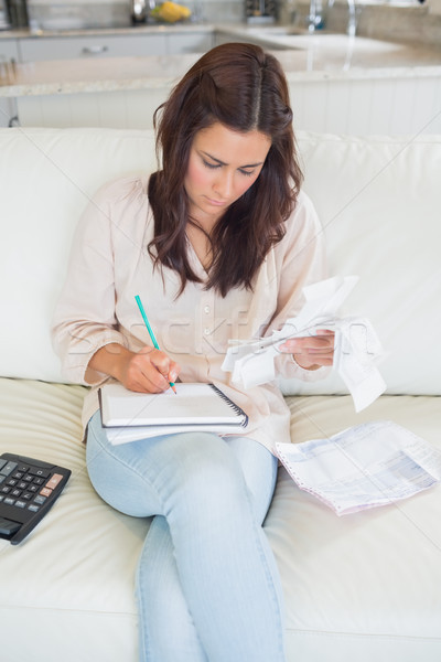 Woman calculating receipts on sofa Stock photo © wavebreak_media