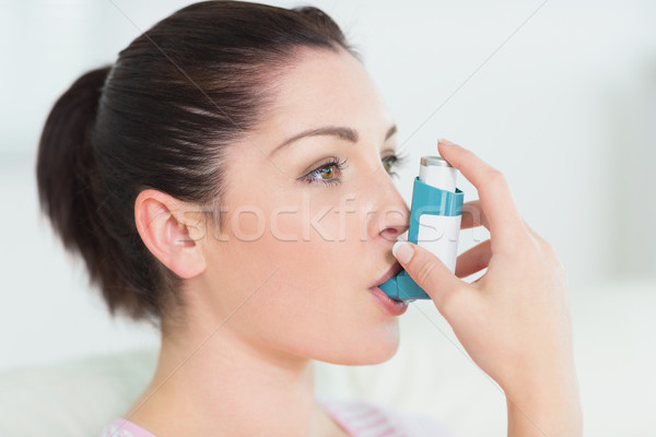 Woman having asthma using the asthma inhaler for being healthy Stock photo © wavebreak_media