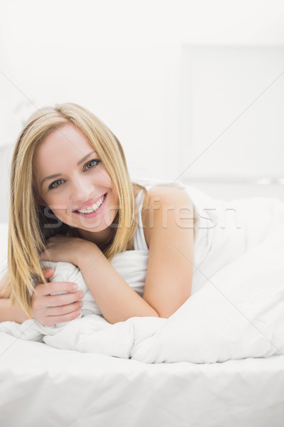 Close-up portrait of smiling young woman in bed Stock photo © wavebreak_media