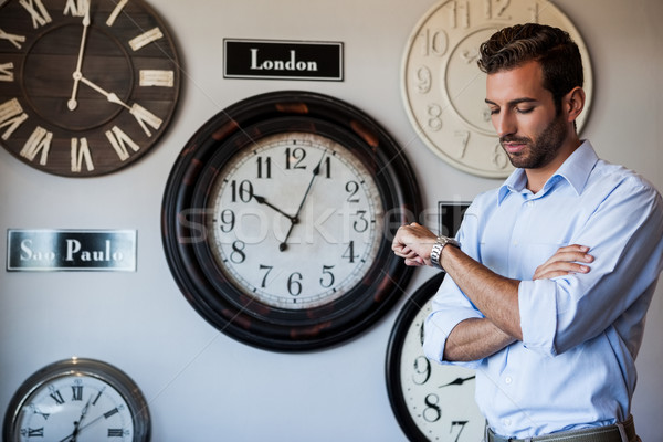 Handsome businessman checking the time Stock photo © wavebreak_media