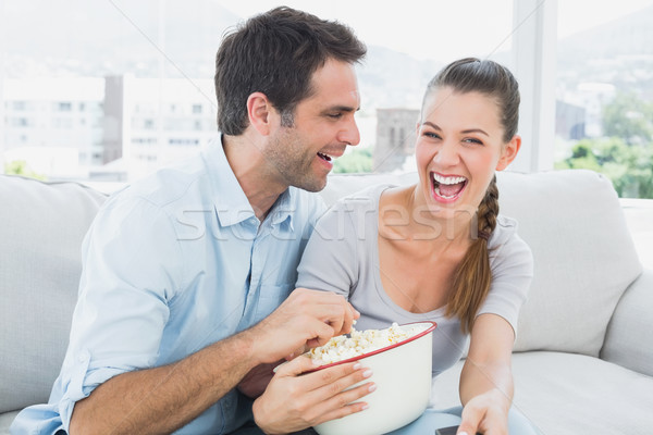 Couple regarder drôle film canapé bol [[stock_photo]] © wavebreak_media