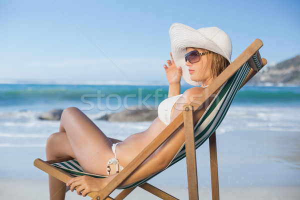 Pretty woman relaxing in deck chair on the beach Stock photo © wavebreak_media