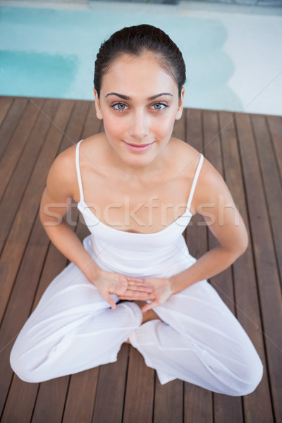 Peaceful brunette in white sitting in lotus pose Stock photo © wavebreak_media