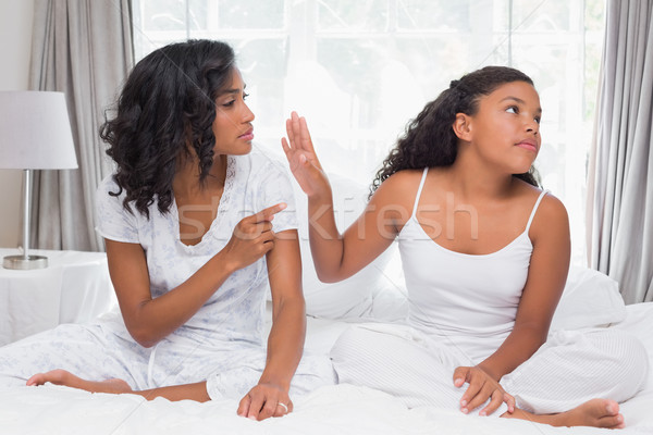 Mother and daughter having an argument on bed Stock photo © wavebreak_media