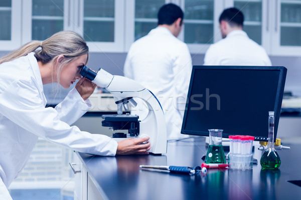 Science student working with microscope in the lab Stock photo © wavebreak_media