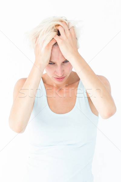 Stock photo: Sad blonde woman with head pain holding her head 