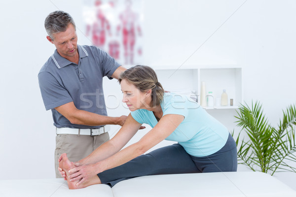 Physiotherapist helping his patient stretching Stock photo © wavebreak_media