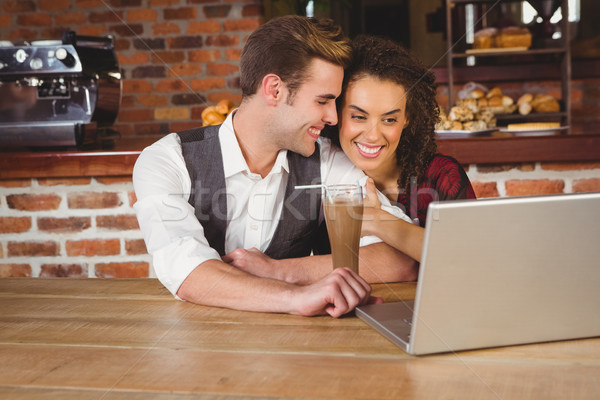  Cute couple on a date watching photos on a laptop Stock photo © wavebreak_media