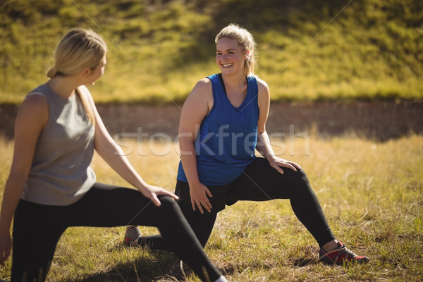 Friends interacting while praising yoga during obstacle course Stock photo © wavebreak_media