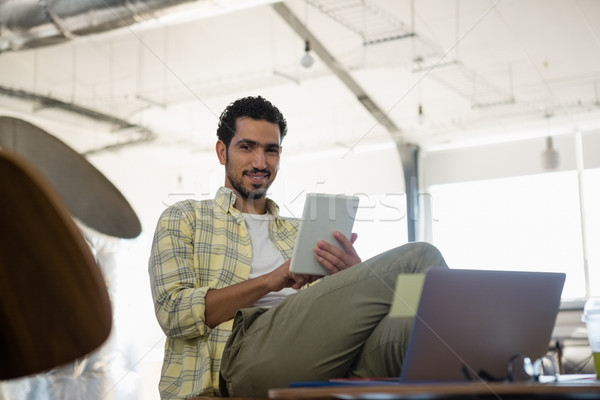 Portrait of young man using tablet in office Stock photo © wavebreak_media