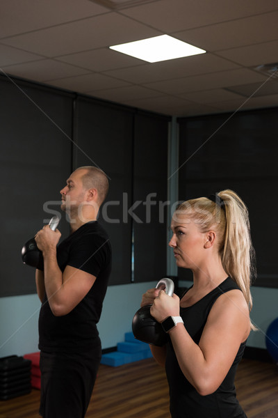 Friends exercising with kettle bells at gym Stock photo © wavebreak_media