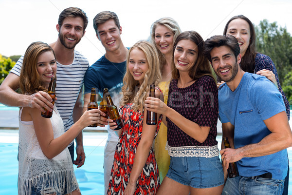 Group of happy friend holding beer bottles Stock photo © wavebreak_media