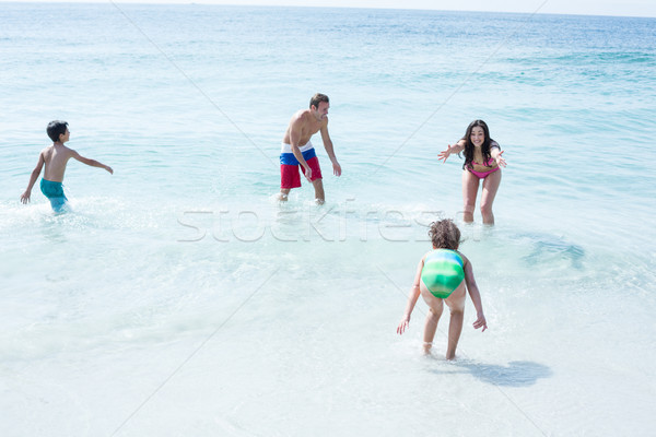 Famille heureuse jouer plage vue femme [[stock_photo]] © wavebreak_media