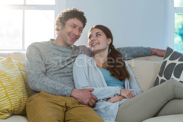 Couple sitting together on sofa Stock photo © wavebreak_media