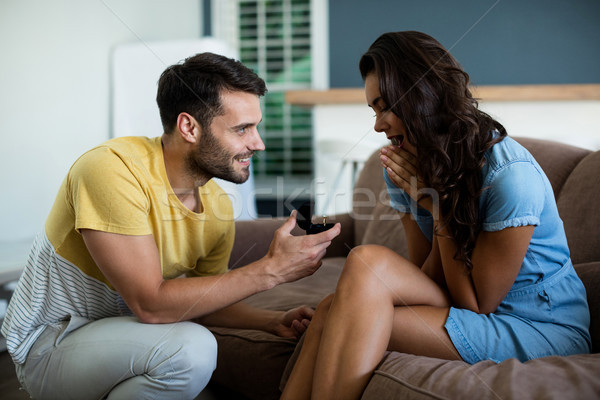 Man offering a engagement ring to woman in the living room Stock photo © wavebreak_media